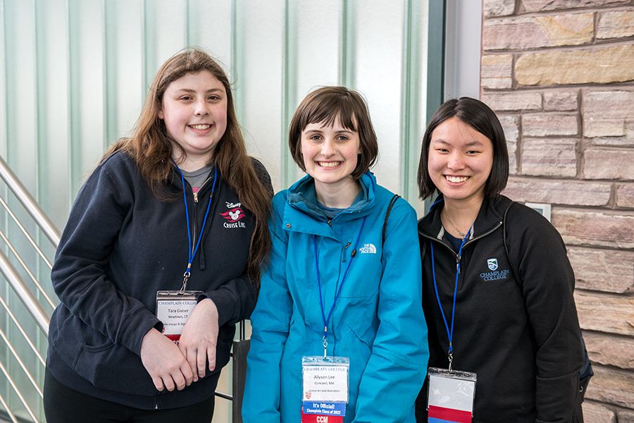 Three students pose in front of the CCM stairwell at Champlain's 2018 Admitted Student Day.