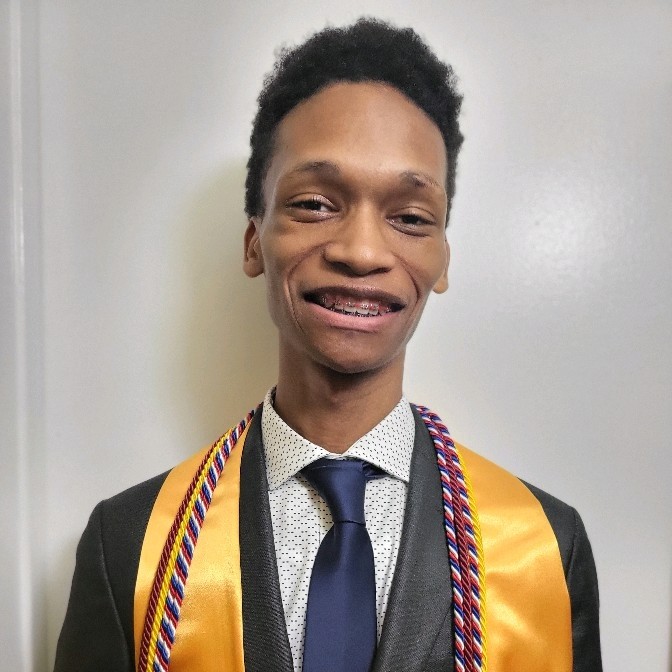 headshot of Denzel Johnson wearing black graduation gown, yellow honors stole, and a navy tie