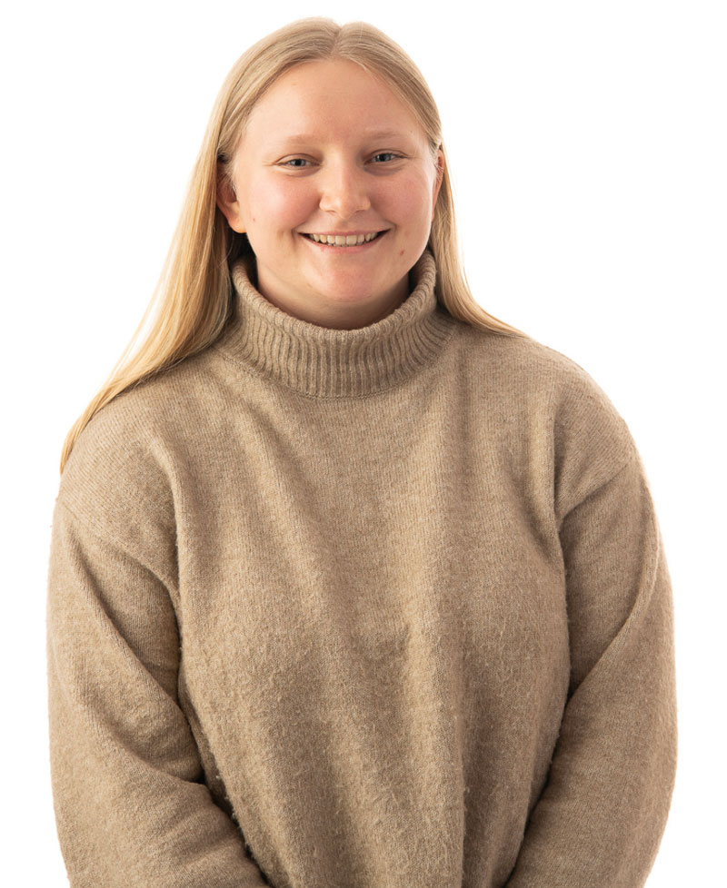 headshot of smiling Olivia Sommerer wearing a tan turtleneck sweater 