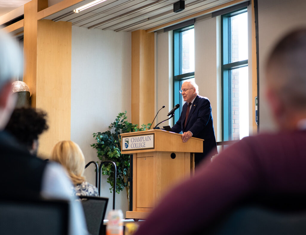 Senator Patrick Leahy speaks at a podium at Champlain College
